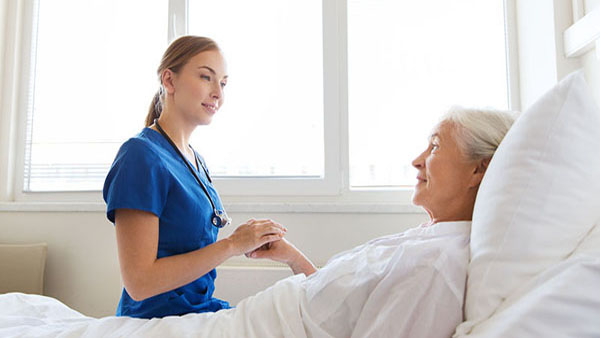 Nurse Visting Senior Woman at Hospital